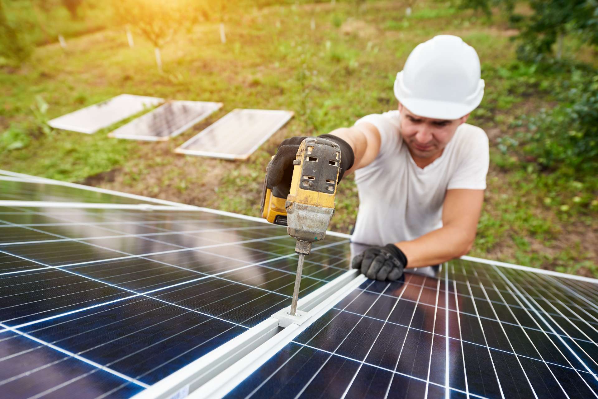 Man mounting solar panel to roof image